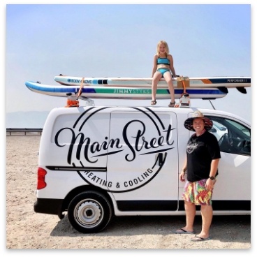 worker with daughter on the beach with main street van
