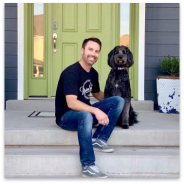 owner with black labradoodle